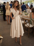 Woman wearing a beige collared wrap waist midi dress - editorial style photo