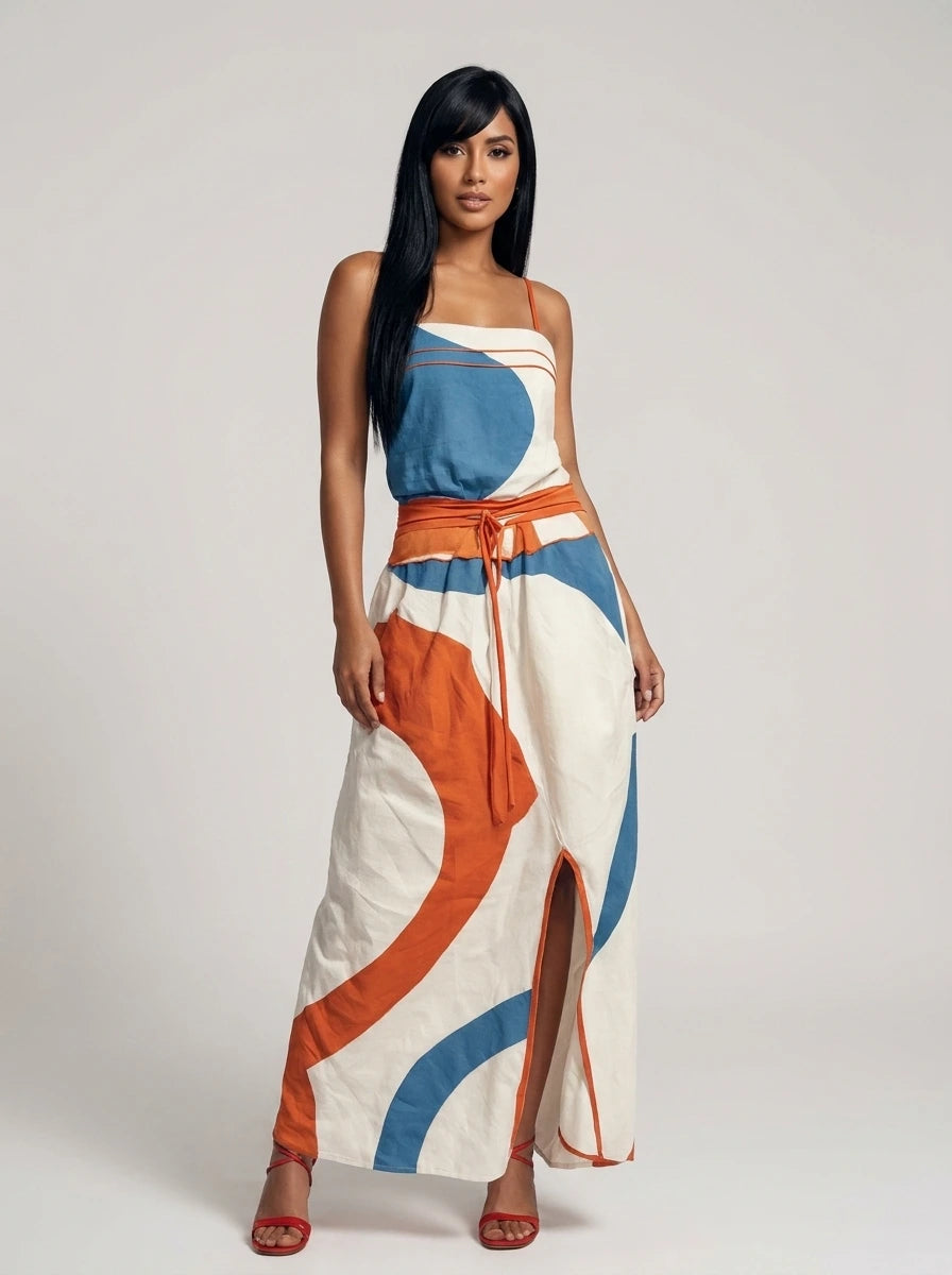 Woman wearing a white color-blocked strapless maxi dress in a studio setting