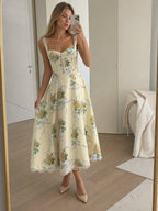 Woman wearing a beige corset style structured bodice midi dress - studio photo