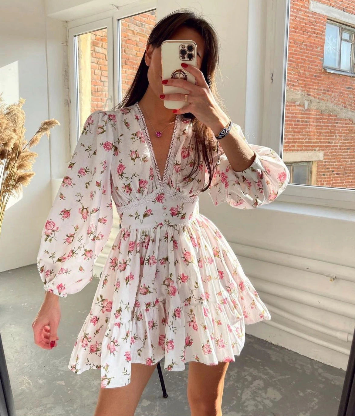Woman wearing a pink crochet lace balloon sleeve mini dress - mirror selfie style photo