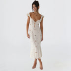Woman wearing a white cut-out fitted midi dress - studio photo