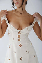 Woman wearing a white cut-out fitted midi dress - studio photo