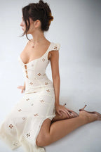 Woman wearing a white cut-out fitted midi dress - studio photo