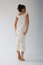 Woman wearing a white cut-out fitted midi dress - studio photo