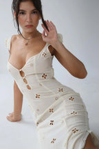 Woman wearing a white cut-out fitted midi dress - studio photo