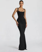 Woman wearing a black draped waist sculpted maxi dress - studio photo