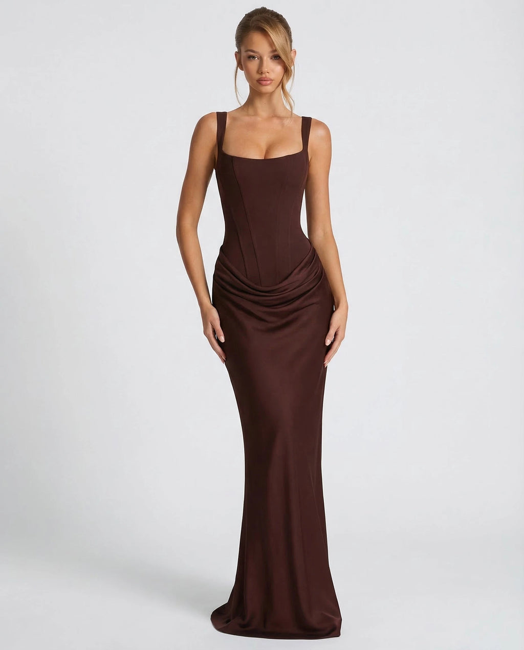 Woman wearing a dark brown draped waist sculpted maxi dress - studio photo