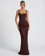Woman wearing a dark brown draped waist sculpted maxi dress - studio photo