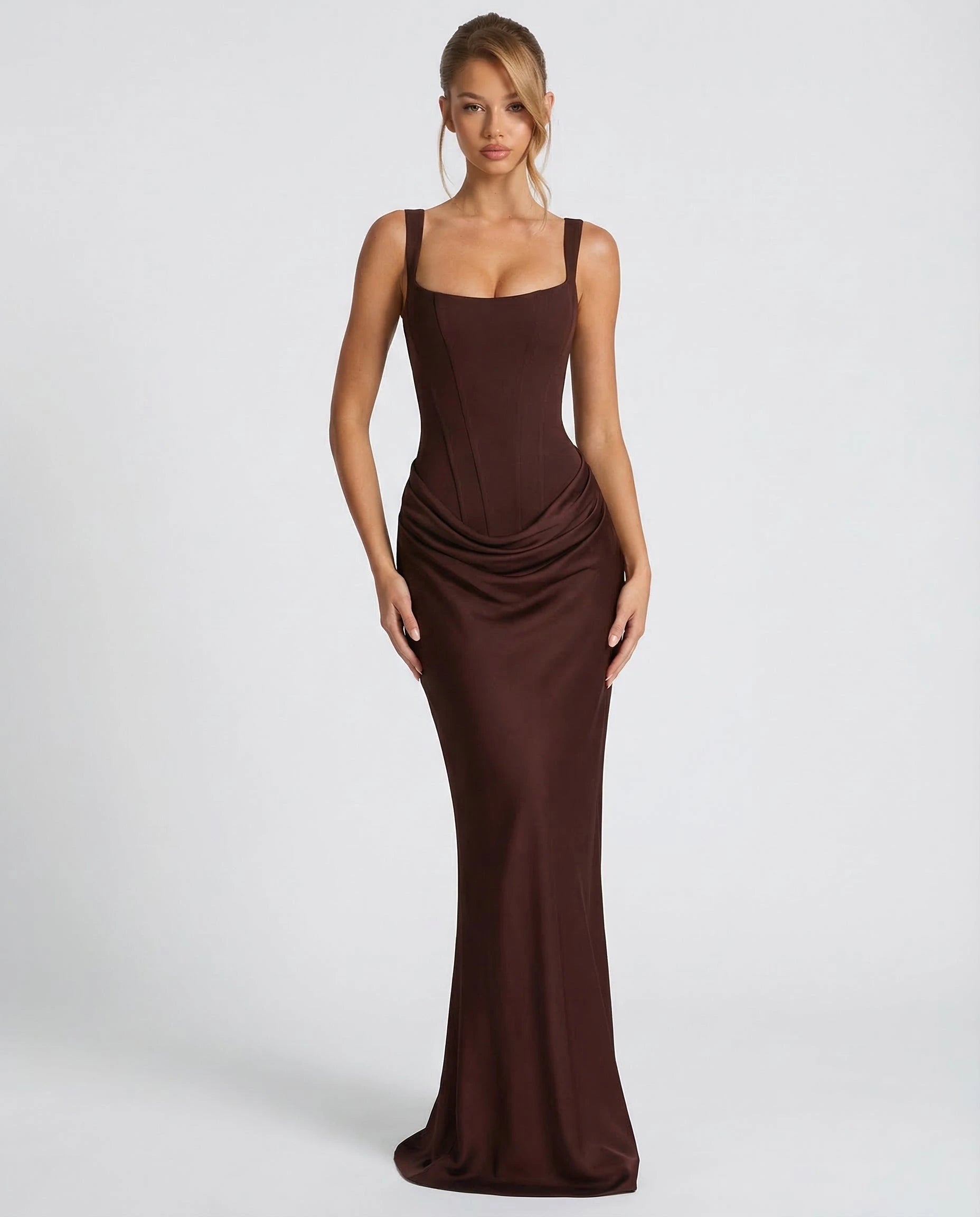 Woman wearing a dark brown draped waist sculpted maxi dress - studio photo