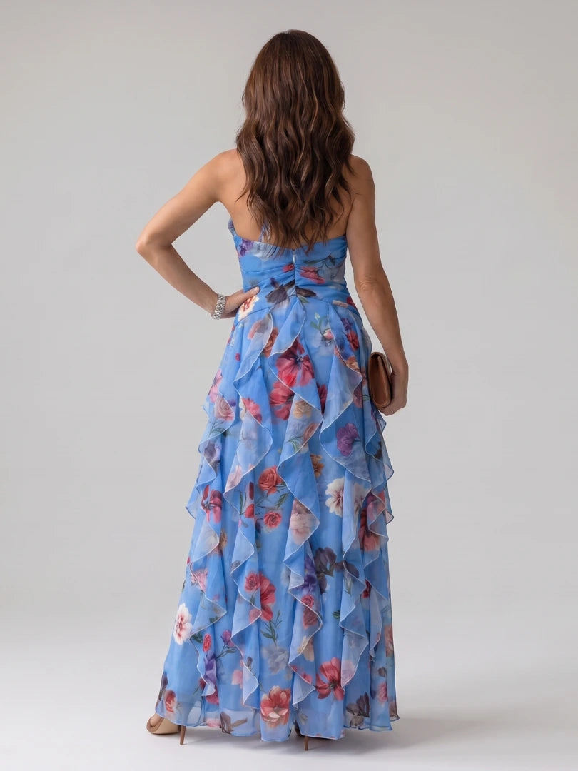 Woman wearing a blue floral halter neck ruched maxi dress - editorial style photo