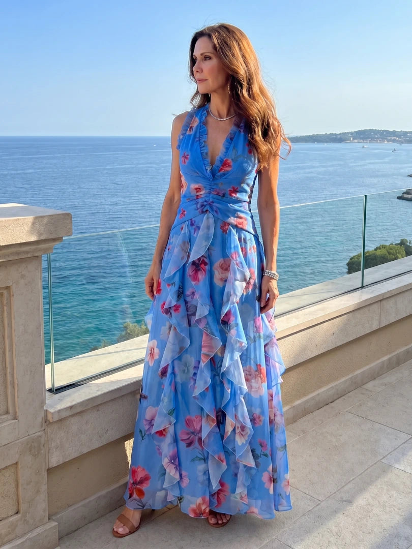 Woman wearing a blue floral halter neck ruched maxi dress - editorial style photo