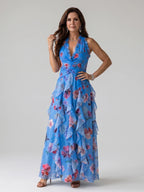 Woman wearing a blue floral halter neck ruched maxi dress - editorial style photo