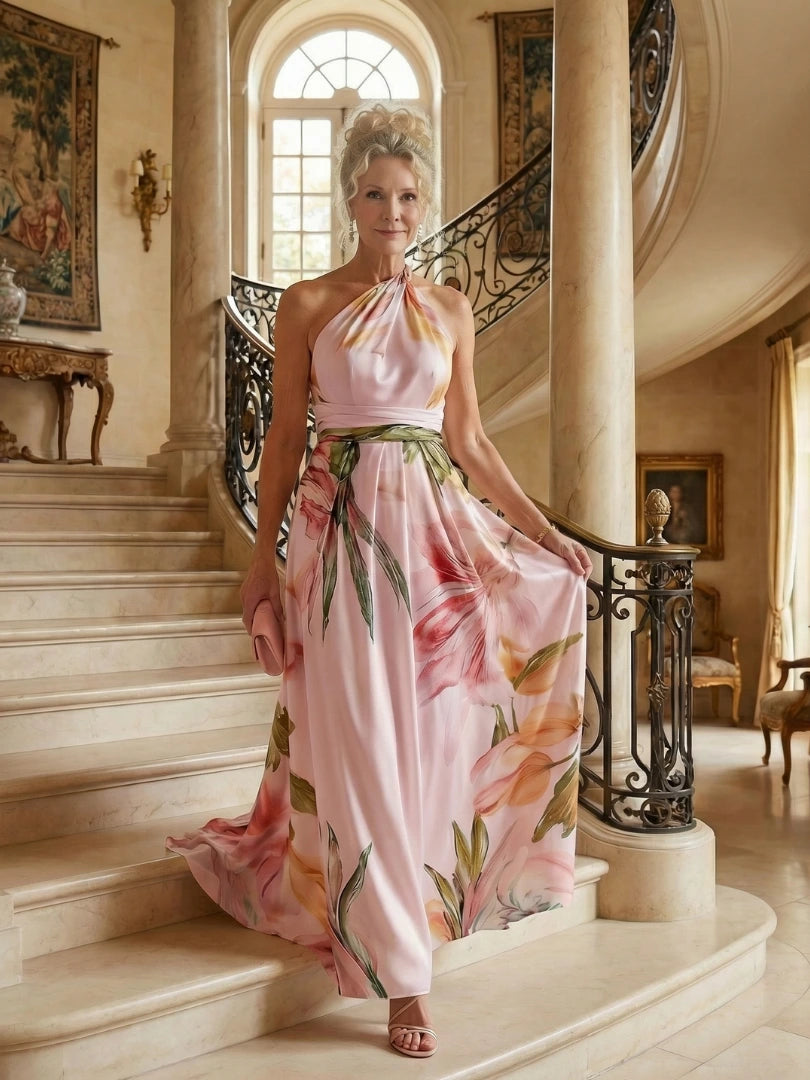 Woman wearing a pink floral halter tie-neck maxi dress - editorial style photo