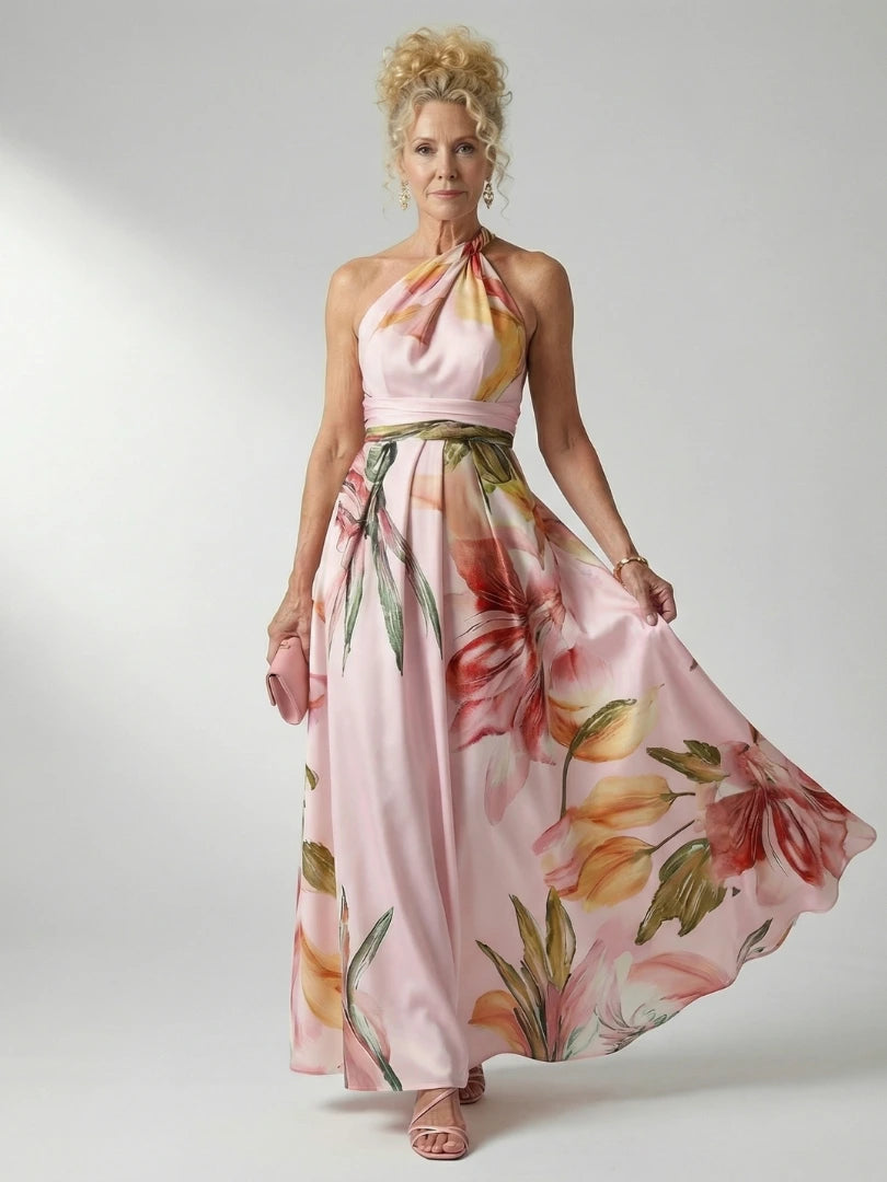 Woman wearing a pink floral halter tie-neck maxi dress - studio photo