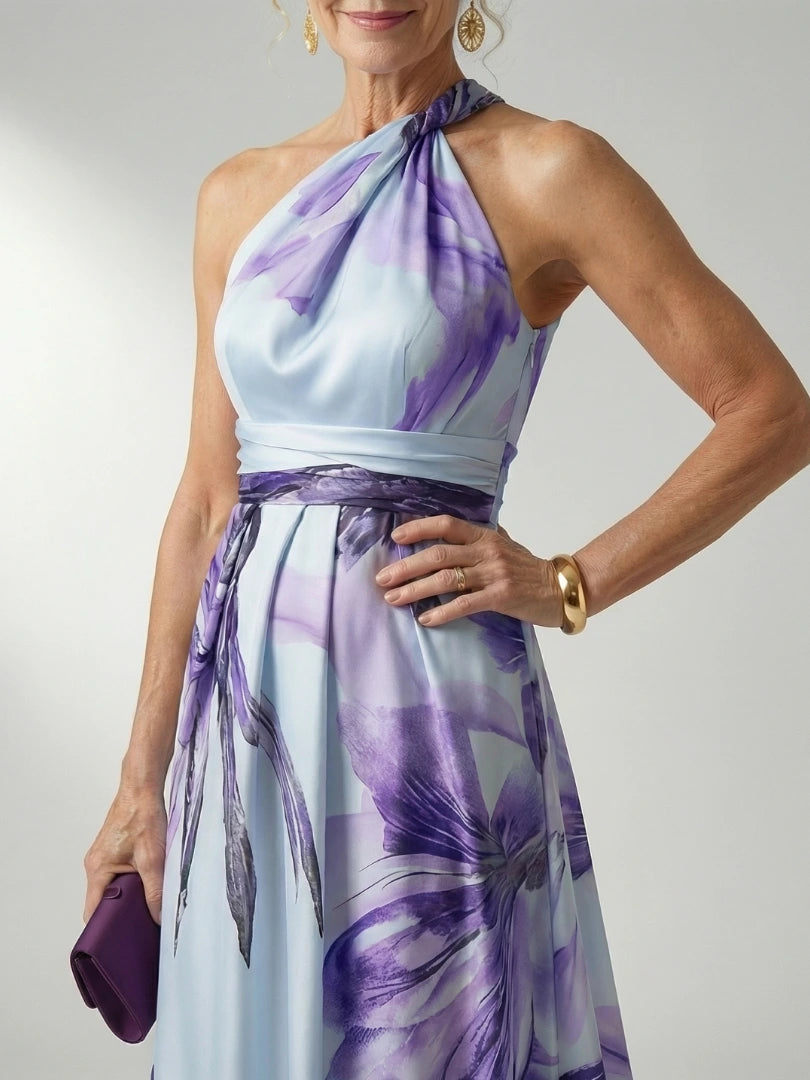 Woman wearing a pink floral halter tie-neck maxi dress - studio photo