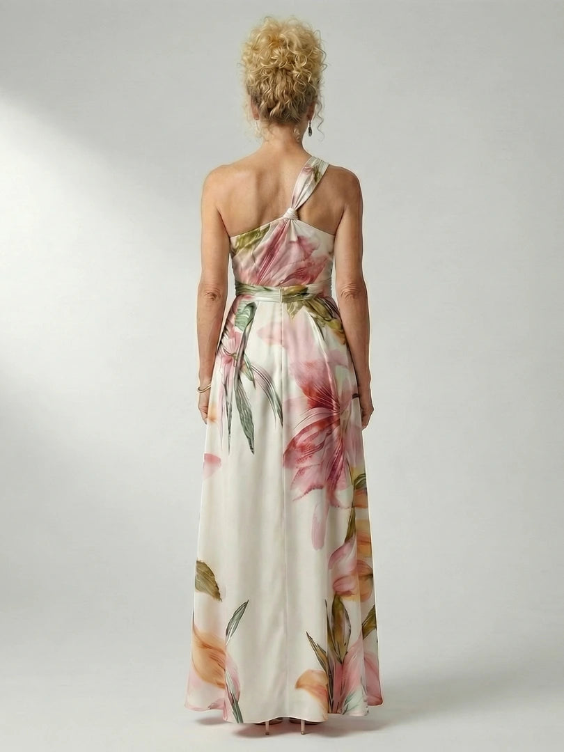 Woman wearing a purple floral halter tie-neck maxi dress - studio photo