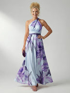 Woman wearing a purple floral halter tie-neck maxi dress - studio photo