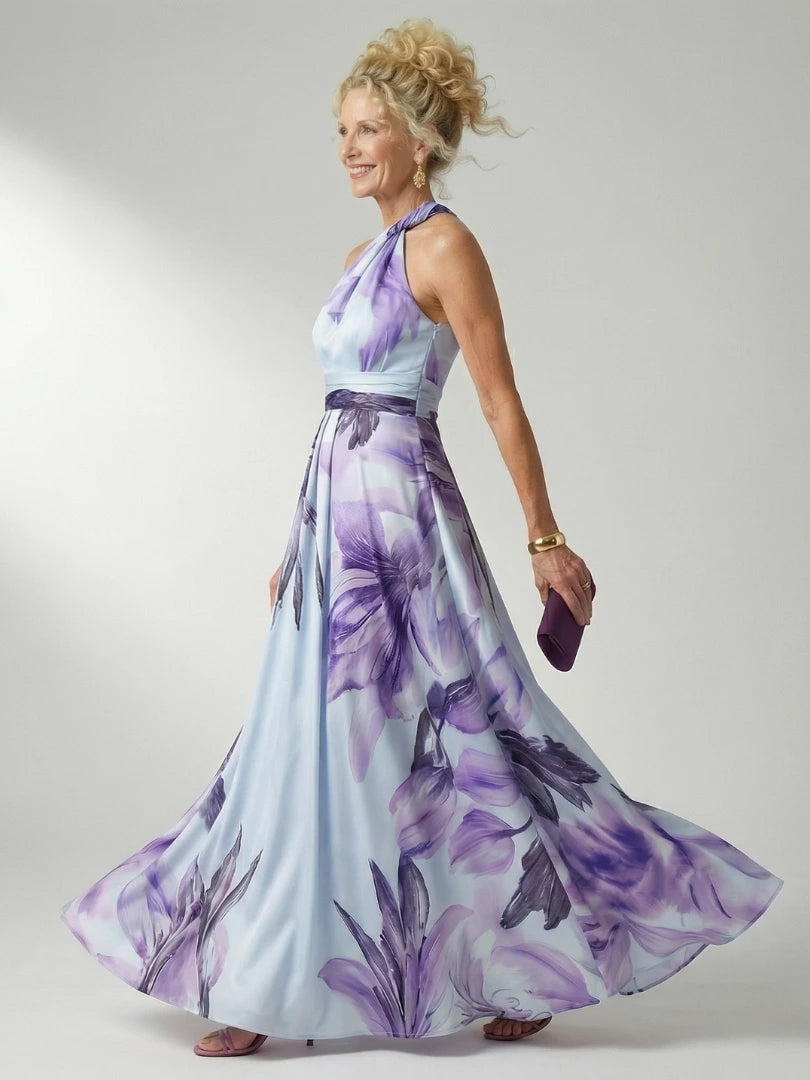Woman wearing a purple floral halter tie-neck maxi dress - studio photo