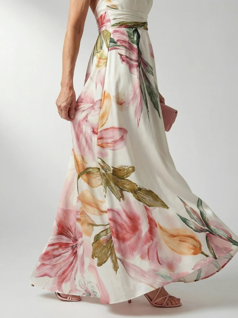 Woman wearing a purple floral halter tie-neck maxi dress - studio photo