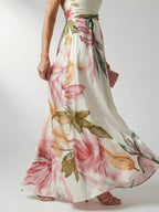Woman wearing a purple floral halter tie-neck maxi dress - studio photo