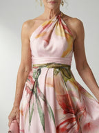 Woman wearing a white floral halter tie-neck maxi dress - editorial style photo