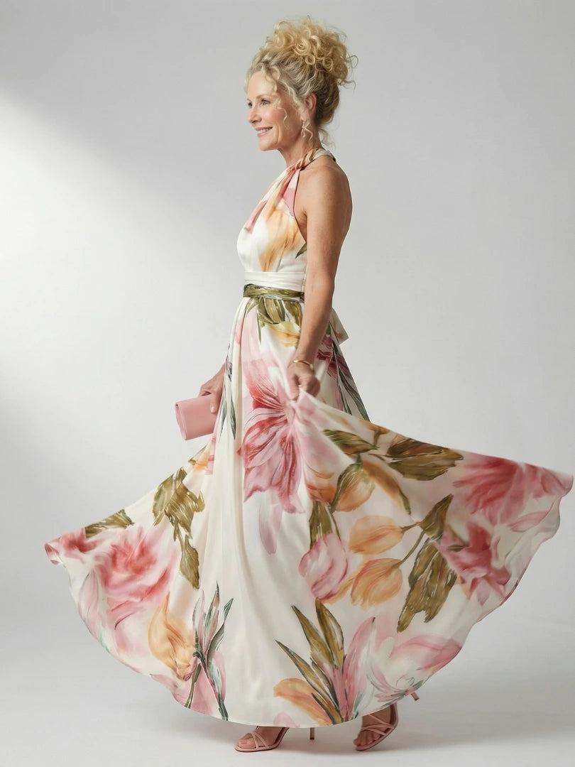 Woman wearing a white floral halter tie-neck maxi dress - studio photo