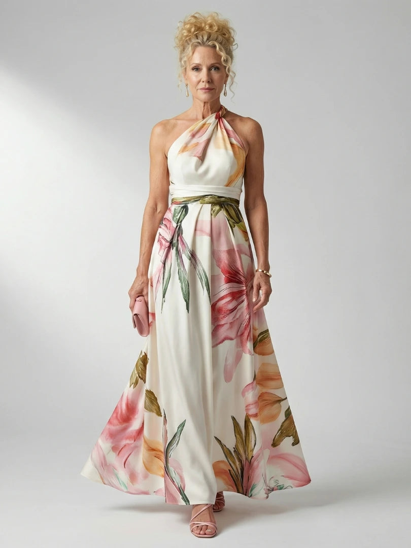 Woman wearing a white floral halter tie-neck maxi dress - studio photo