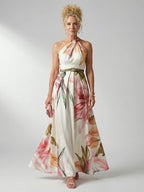Woman wearing a white floral halter tie-neck maxi dress - studio photo