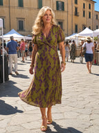 Woman wearing a floral relaxed midi dress - editorial style photo