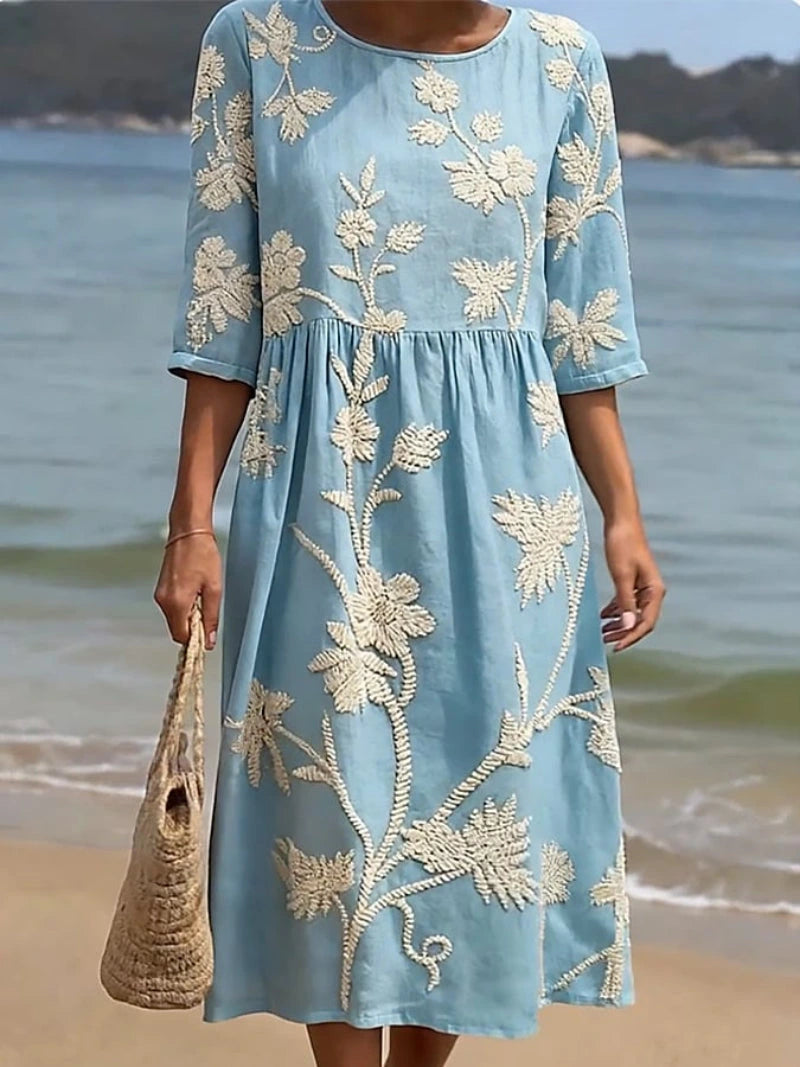 Woman wearing a blue floral round neck midi dress - lifestyle photo