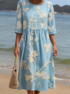 Woman wearing a blue floral round neck midi dress - lifestyle photo
