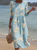 Woman wearing a blue floral round neck midi dress - lifestyle photo