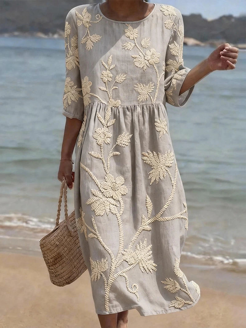 Woman wearing a grey floral round neck midi dress - lifestyle photo