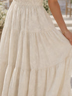 Woman wearing a beige floral textured short sleeve midi dress - studio photo