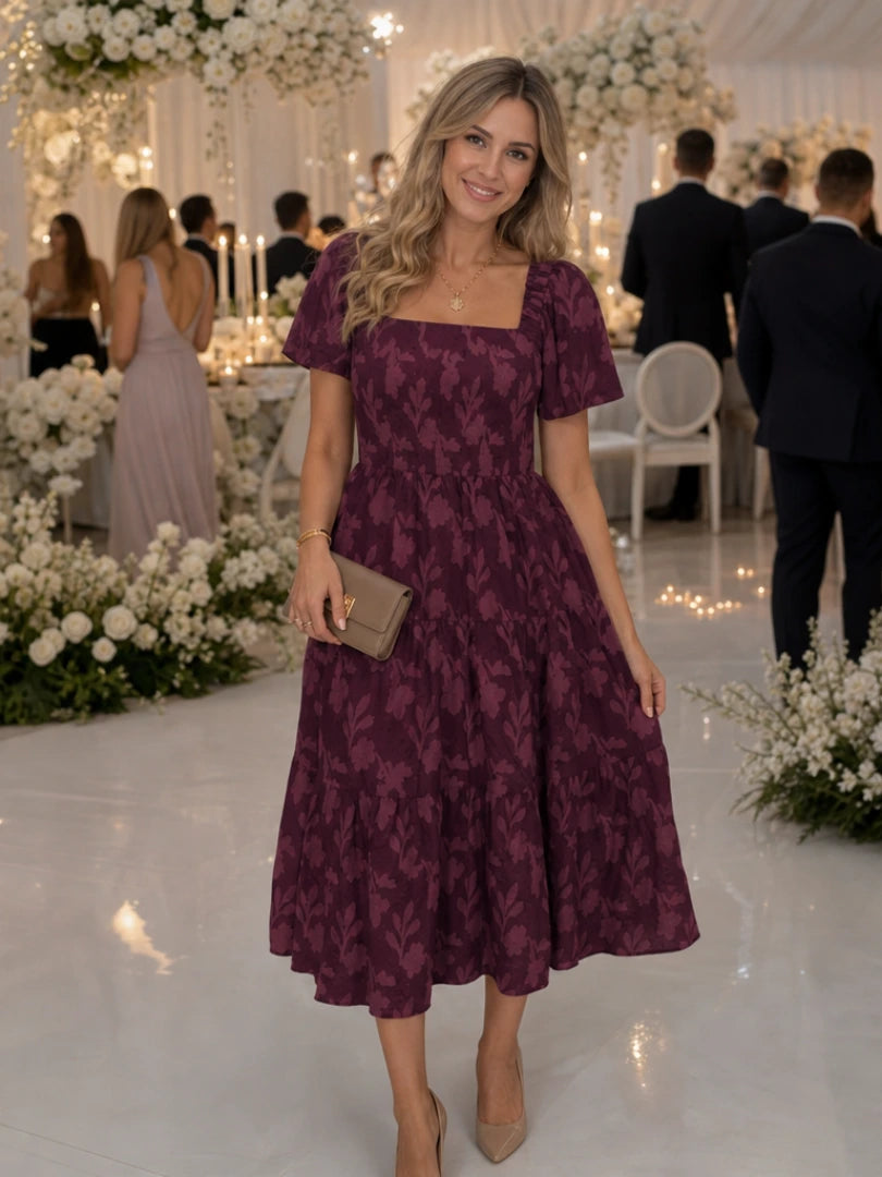 Woman wearing a burgundy floral textured short sleeve midi dress - editorial style photo