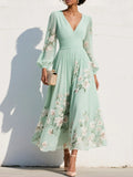Woman wearing a light green floral v-neck chiffon midi dress - studio photo
