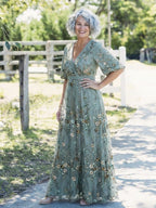 Woman wearing a green floral v-neck elbow-sleeve maxi dress - lifestyle photo
