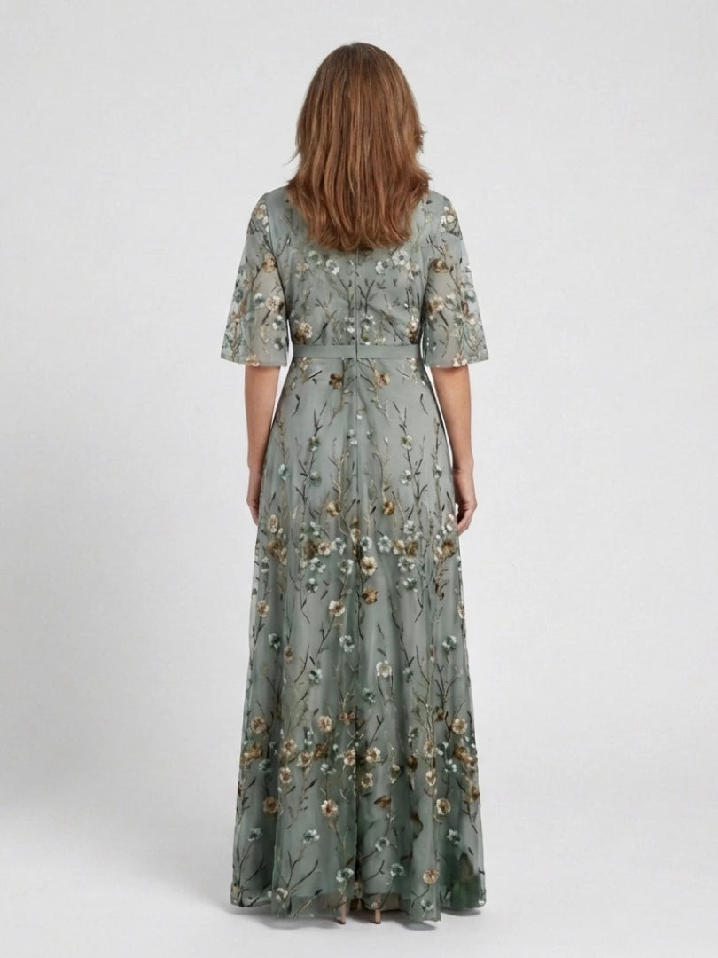 Woman wearing a green floral v-neck elbow-sleeve maxi dress - studio photo