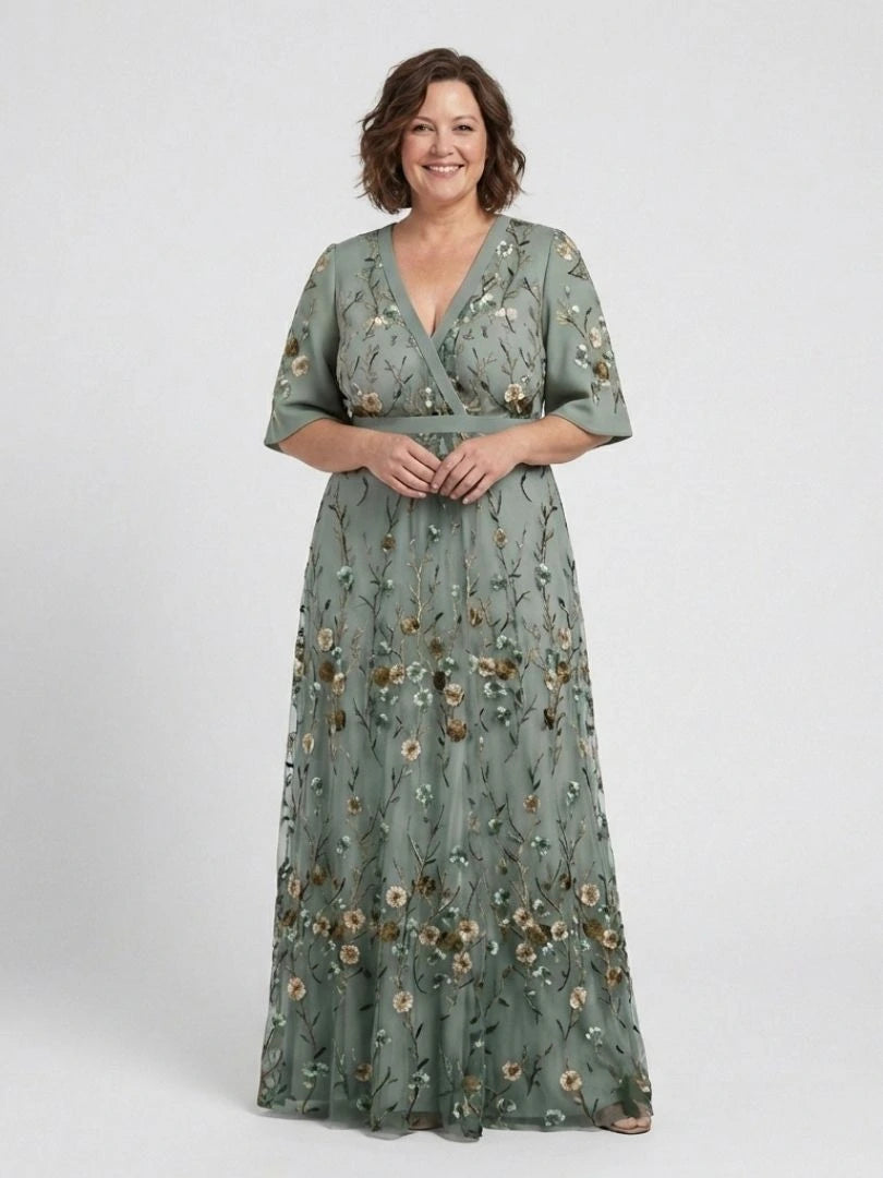 Woman wearing a green floral v-neck elbow-sleeve maxi dress - studio photo