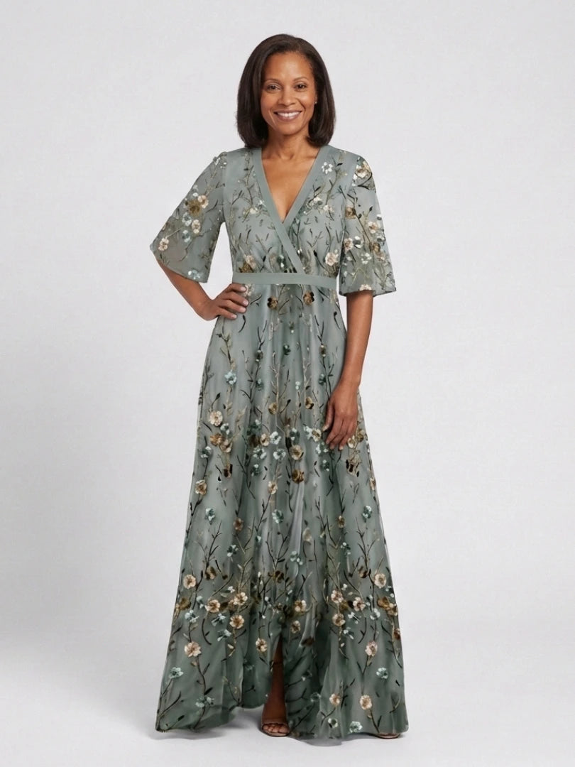 Woman wearing a green floral v-neck elbow-sleeve maxi dress - studio photo