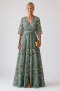 Woman wearing a green floral v-neck elbow-sleeve maxi dress - studio photo