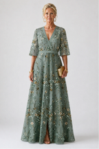 Woman wearing a green floral v-neck elbow-sleeve maxi dress - studio photo