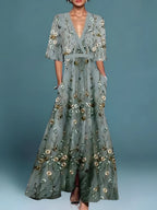 Woman wearing a green floral v-neck elegant dress - studio photo