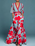 Woman wearing a red floral v-neck elegant dress - studio photo