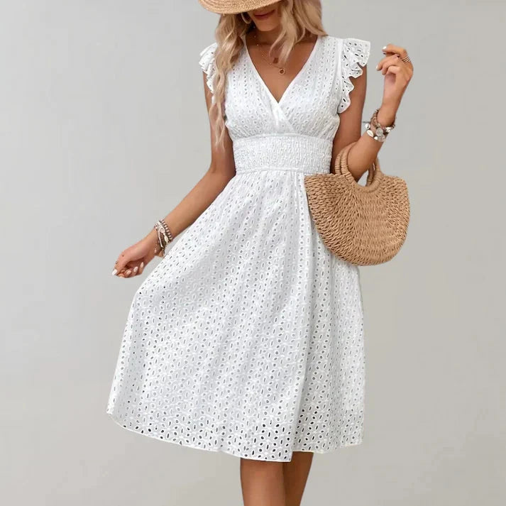 Woman wearing a white flutter sleeve midi dress - outdoor lifestyle photo