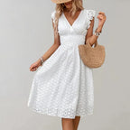 Woman wearing a white flutter sleeve midi dress - outdoor lifestyle photo