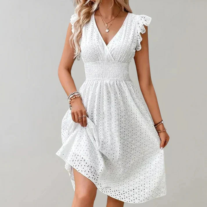 Woman wearing a white flutter sleeve midi dress - outdoor lifestyle photo