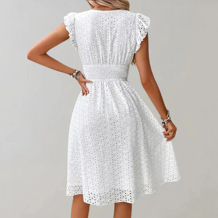Woman wearing a white flutter sleeve midi dress - outdoor lifestyle photo