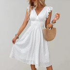 Woman wearing a white flutter sleeve midi dress - outdoor lifestyle photo