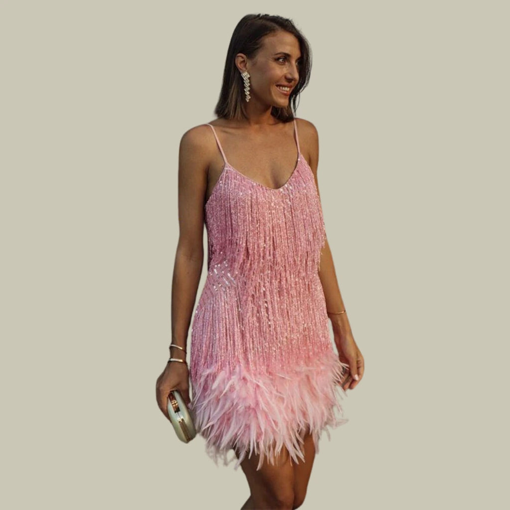 Woman wearing a pink fringe hem mini dress - studio photo